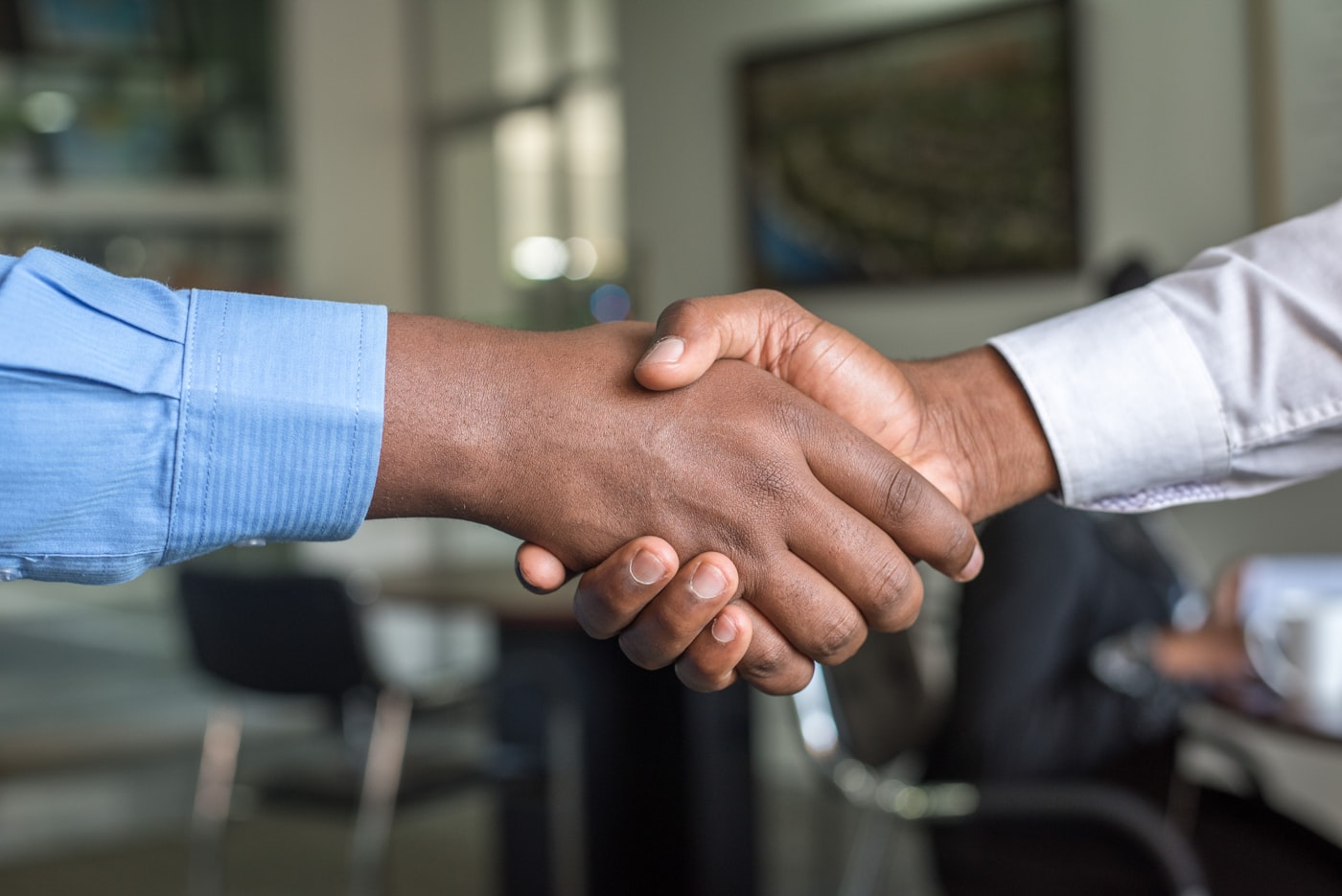 Advisor and client shaking hands after a successful loan agreement